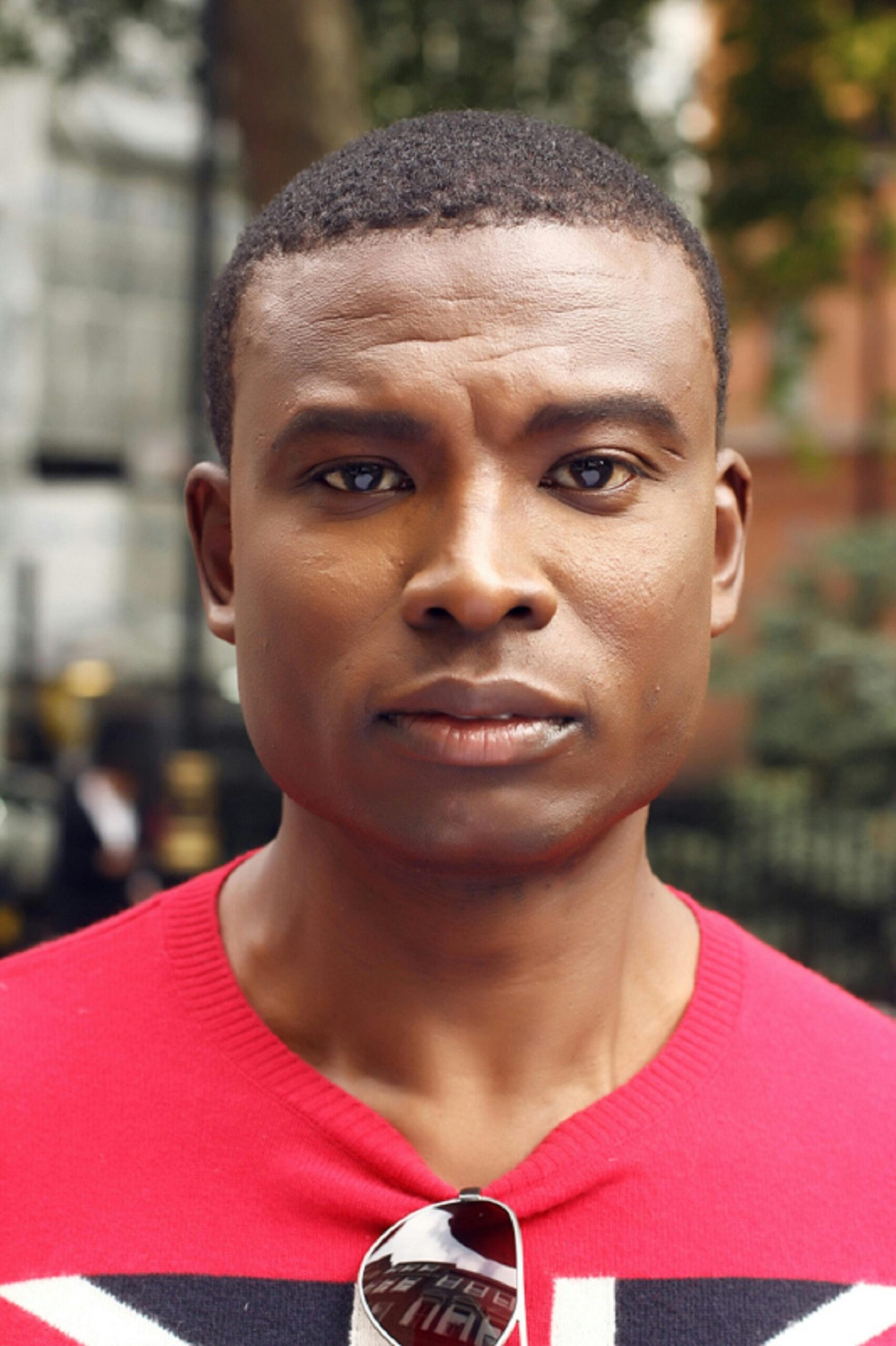 Close-up portrait of a man outdoors in Greater London, showcasing confidence and style.